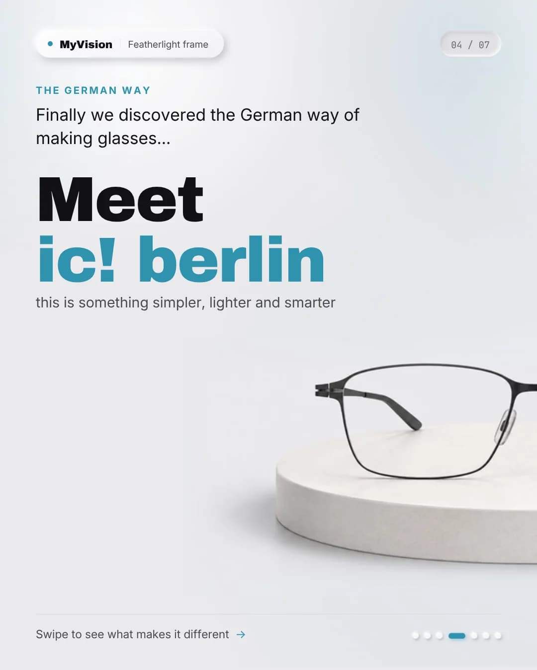 A slim black ic! berlin metal frame standing on a pale stone podium.